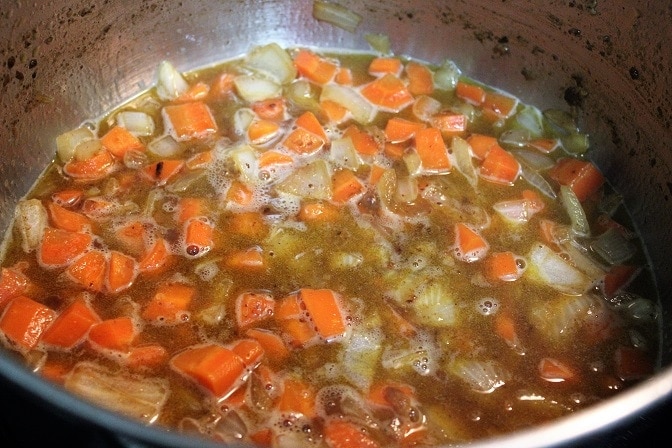 broth, veggies and veal in pot