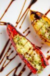 close up of 2 stuffed mini peppers with goat cheese