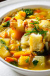 Root vegetable soup with croutons in a bowl.