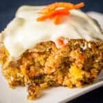 piece of carrot cake with frosting on plate