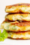 stack of 4 mashed potato pancakes on plate.