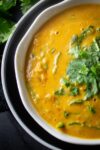 Curried Lentil Soup in a bowl garnished with chopped cilantro