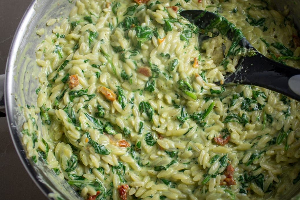 Parmesan Orzo with spinach in pan