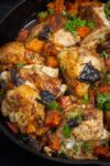 Moroccan chicken in skillet with sweet potatoes prunes onions p