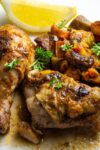 two pieces Moroccan roast chicken with sweet potatoes medley on plate with lemon wedge p3