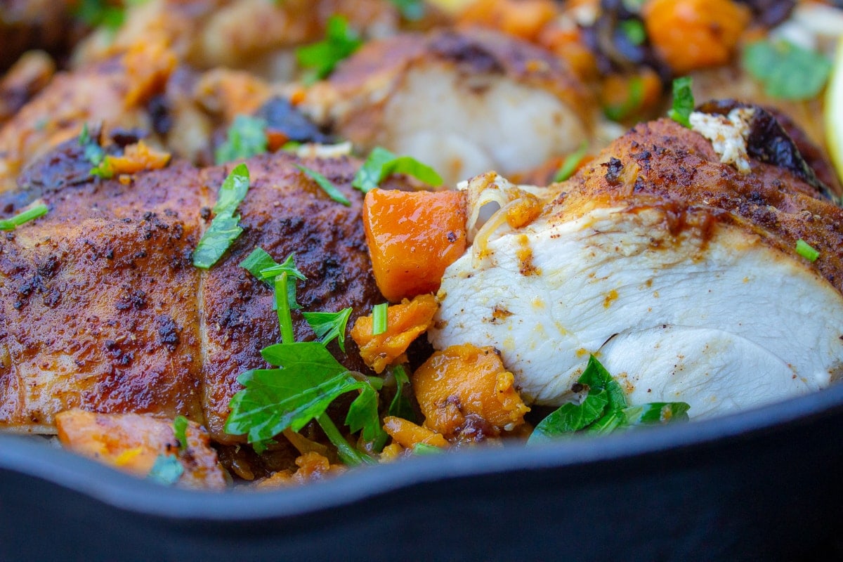 close up of Moroccan roast chicken with sweet potatoes in a skillet 1