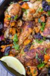 Moroccan roast chicken with sweet potatoes and prunes in skillet