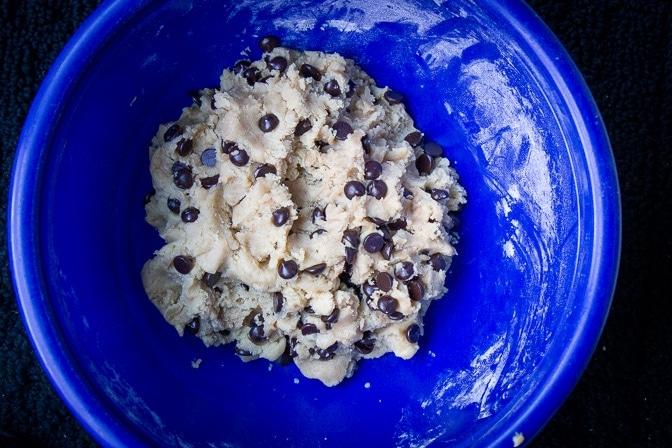 chocolate chip cookie bar dough with chocolate chips in a blue bowl