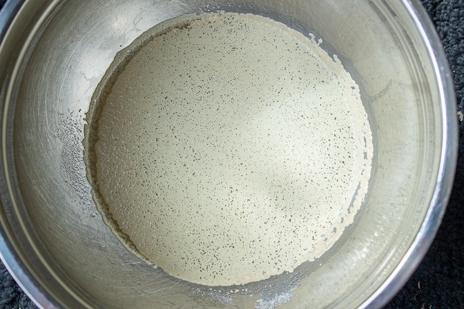 warm water with sugar and yeast in bowl