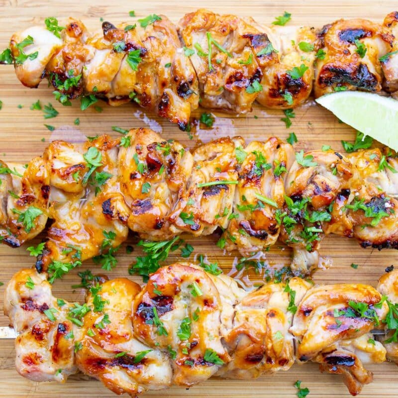 3 chicken thigh skewers on cutting board