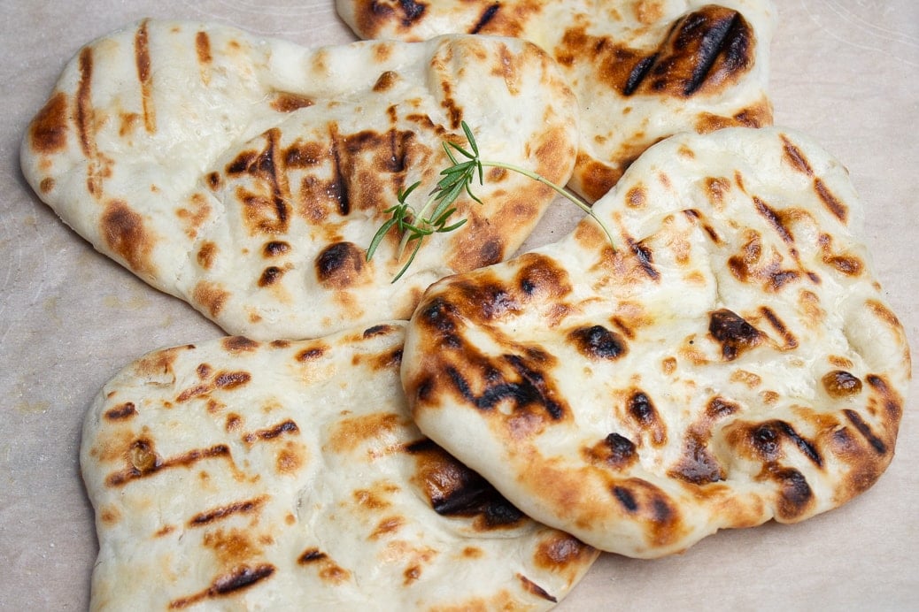 pieces of naan on cutting board