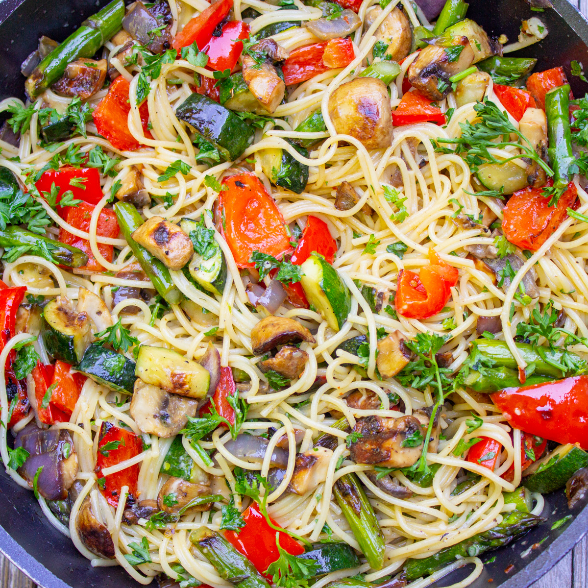 pasta with vegetables in wine sauce in skillet