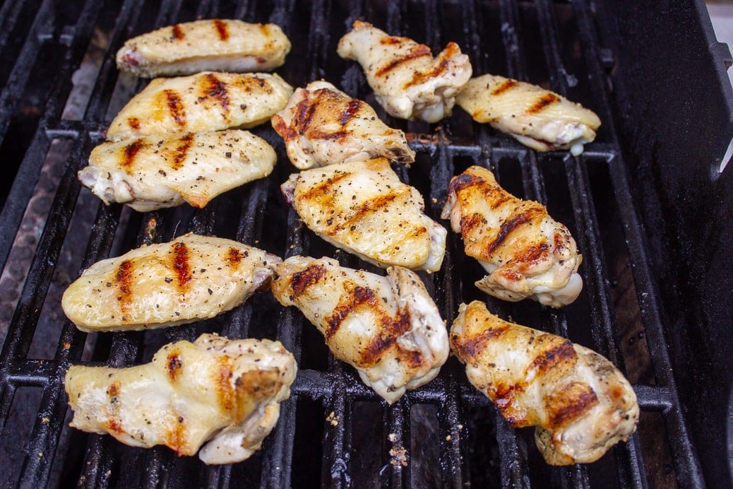 partially cooked wings on grill