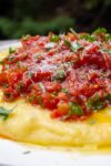 Creamy polenta on a plate with tomato herb salad p4