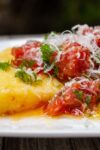 plate of polenta topped with tomato herb salad p3
