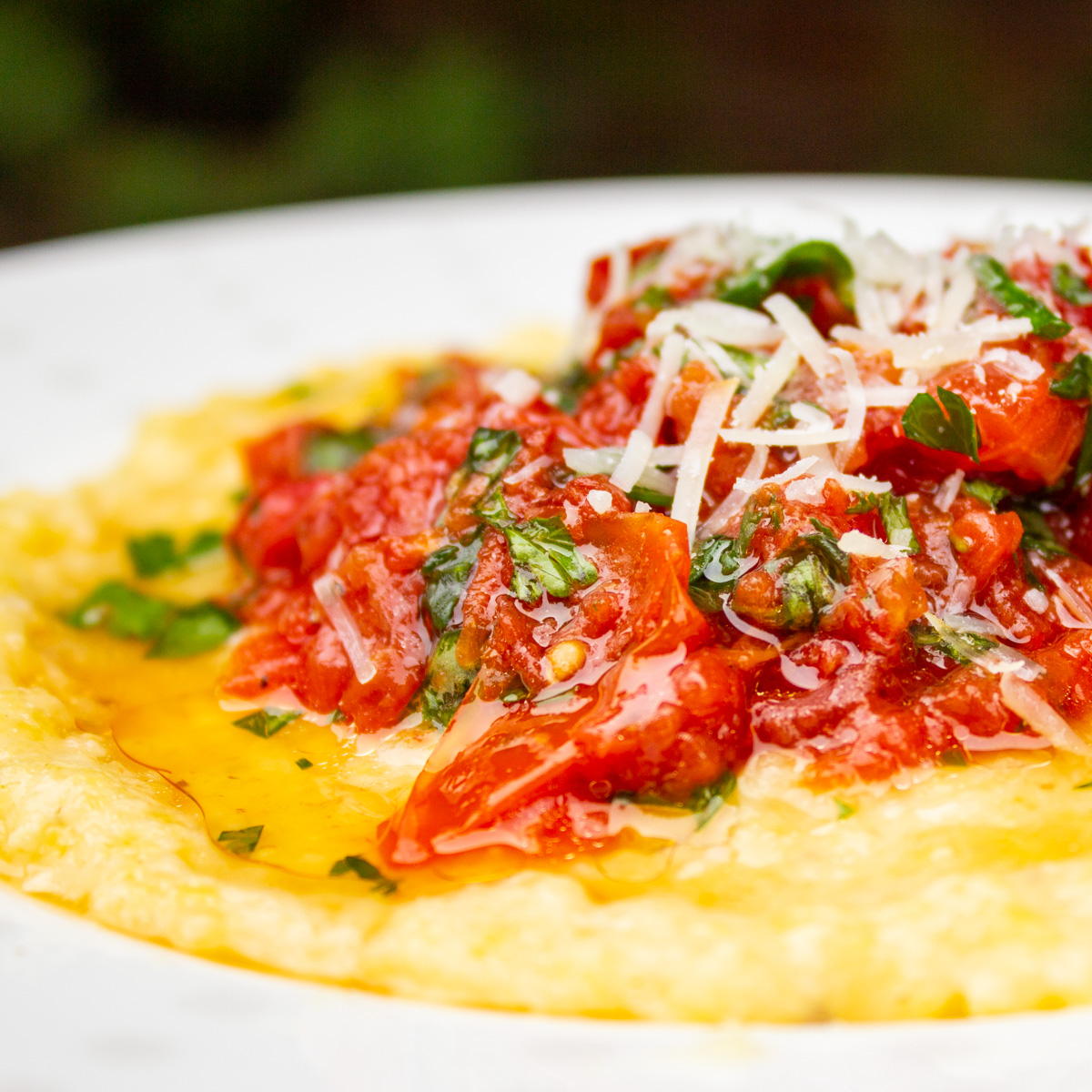 polenta topped with tomato salad on plate