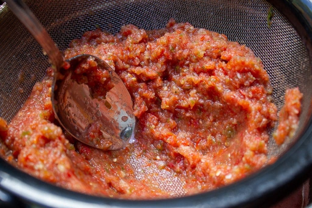 vegetable mixture straining in a sieve