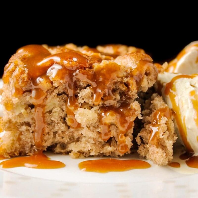 piece of apple cake with caramel sauce and ice cream