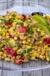 Corn and tomato salad with quinoa on glass plate p