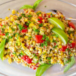 corn tomato and quinoa salad on glass plate