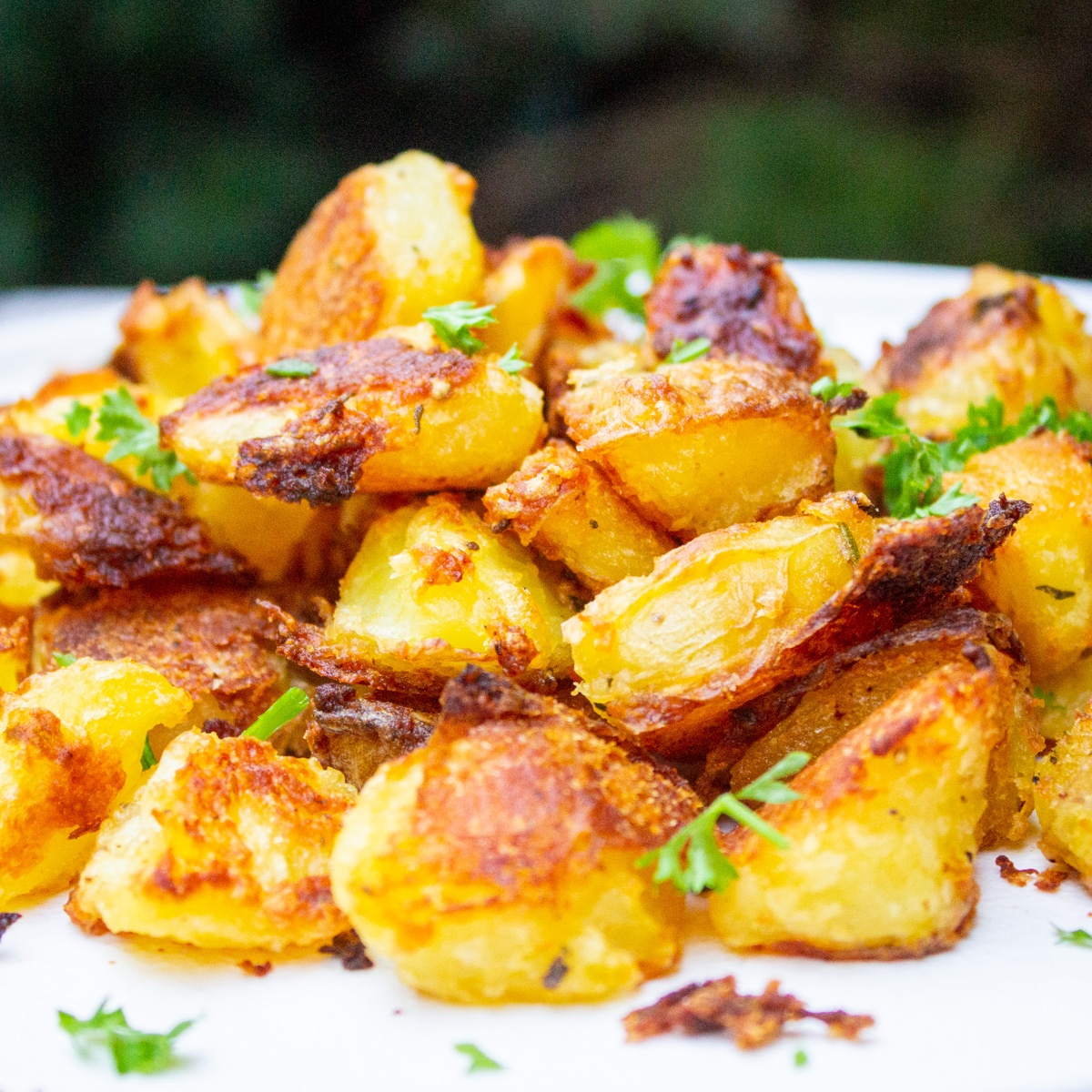 pile of roasted potatoes on white plate