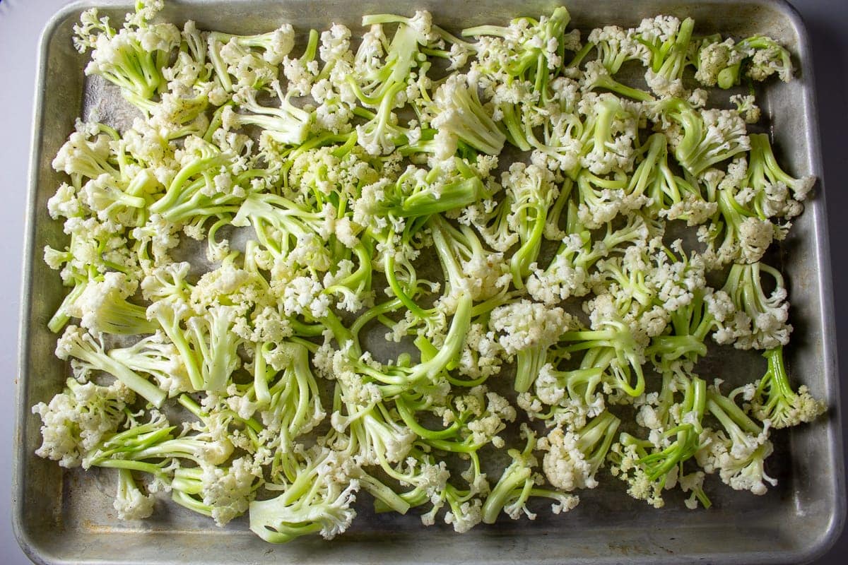 baby cauliflower pieces on pan before roasting
