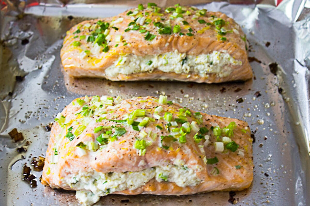 two baked salmon fillets stuffed with ricotta on pan