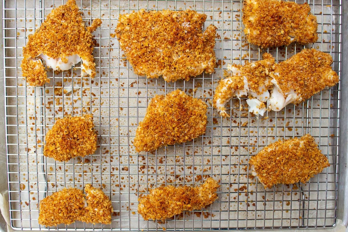 breaded baked fish on rack over a pan