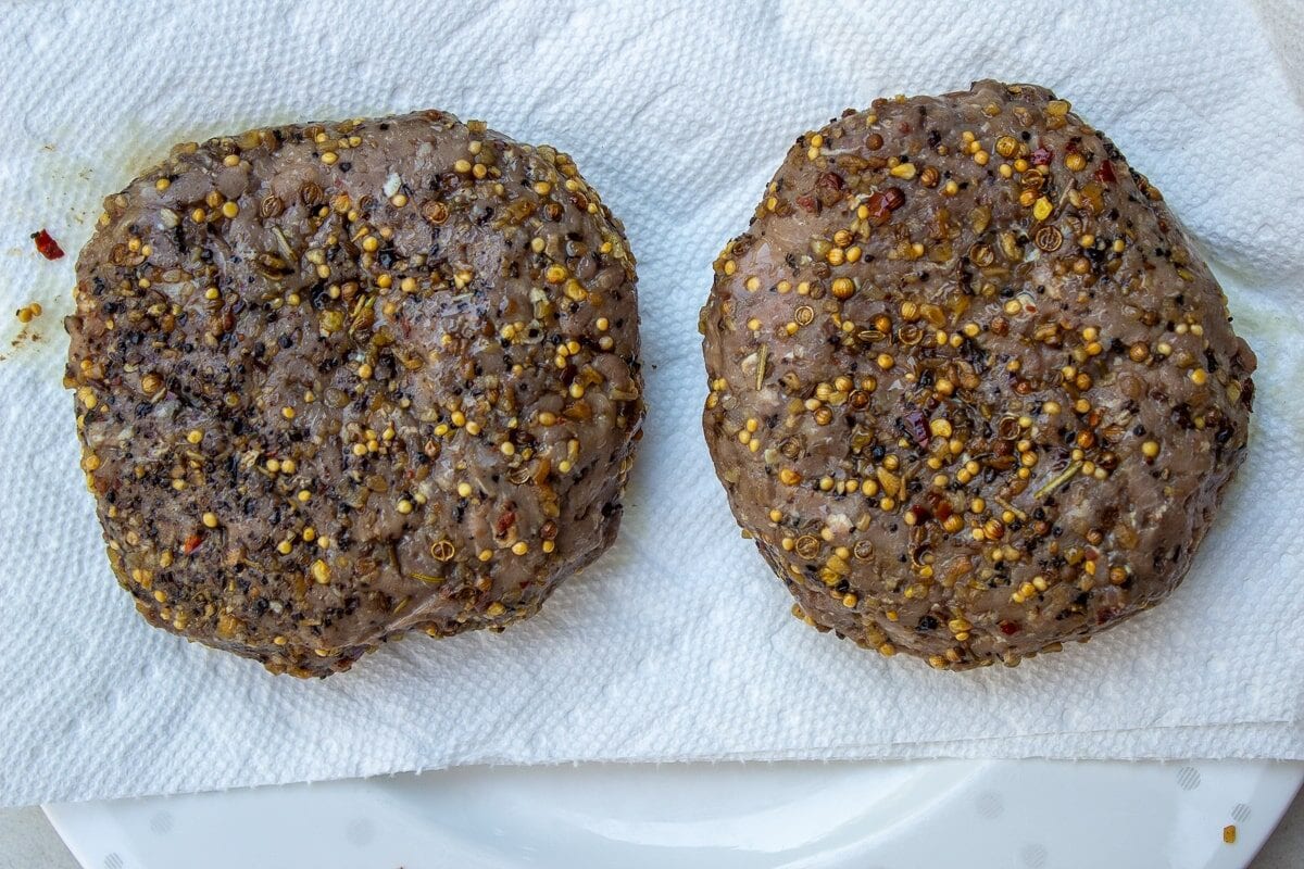 Cooked burgers patted dry with paper towel.