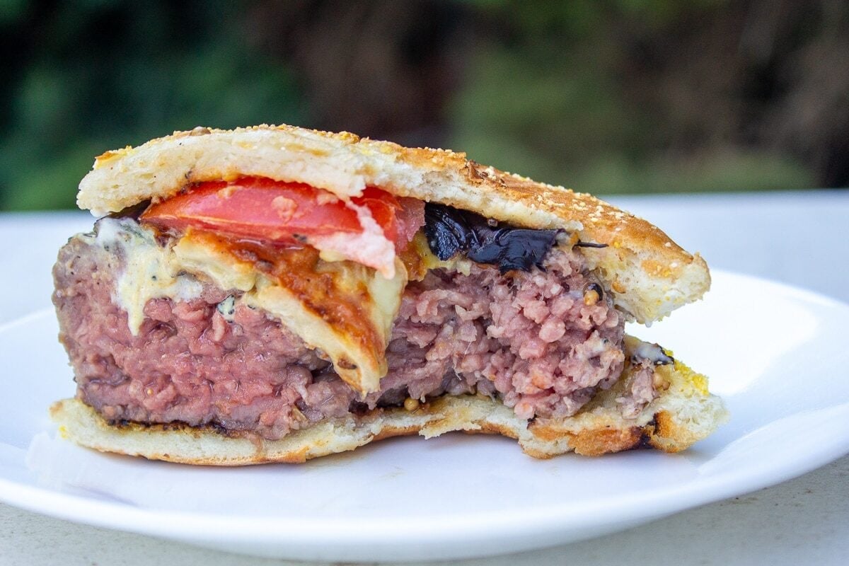 Half a sous vide burger in bun with bit taken. Temp 134F.