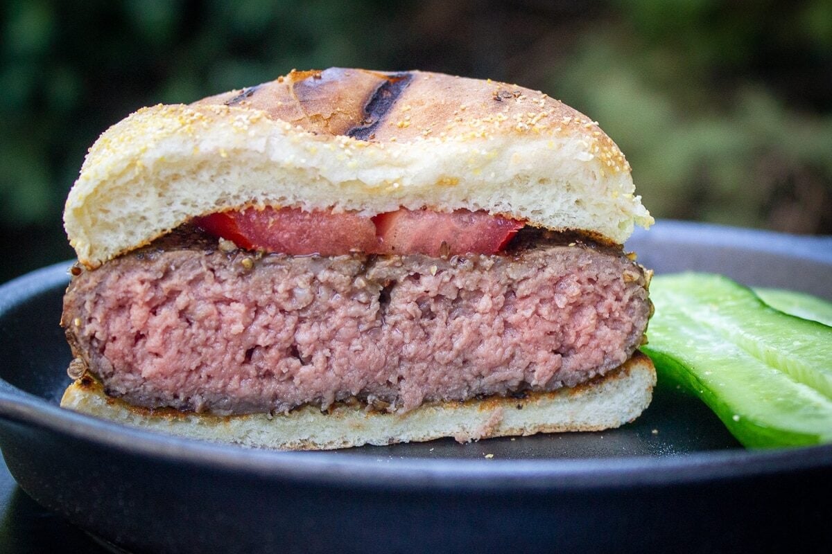 Half a sous vide burger on plate on bun with tomato slice. Temp 138F.