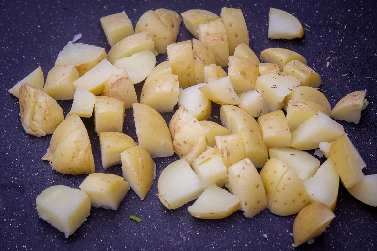 microwaved cooked potatoes diced on cutting board