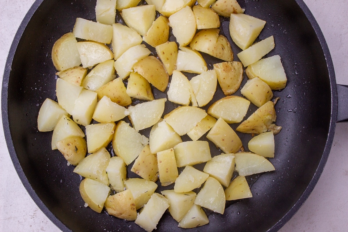 parcooked potatoes in skillet