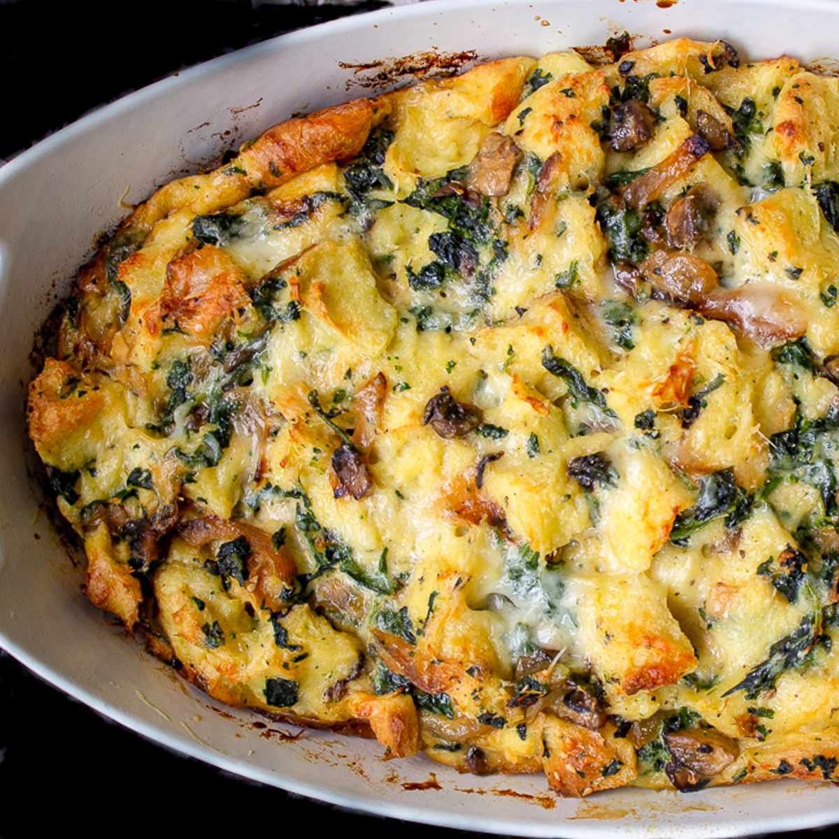 baked strata in casserole dish on table