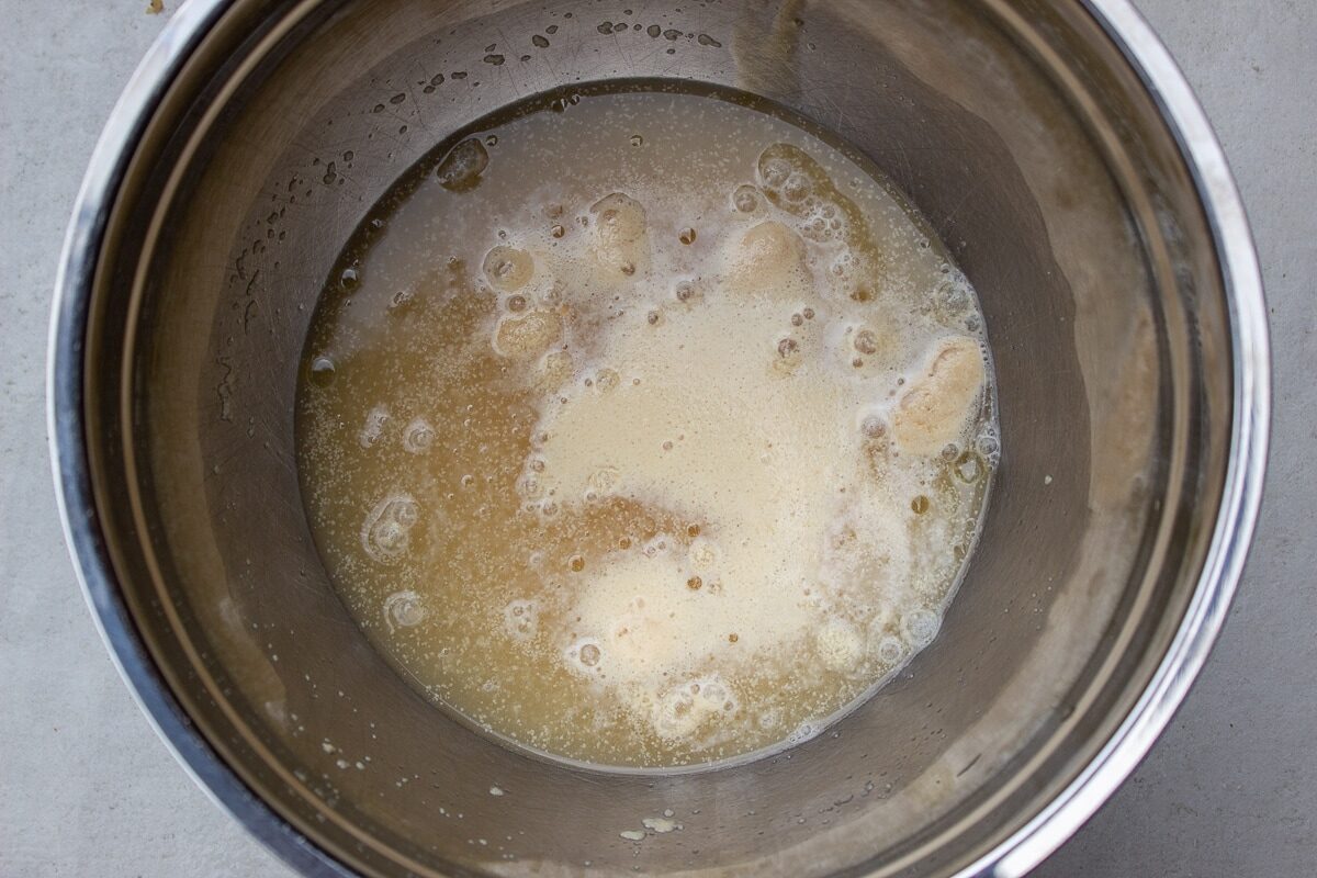 water, yeast and sugar in bowl