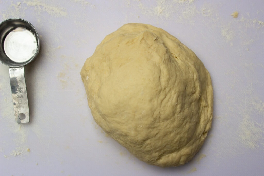 kneaded dough on cutting board