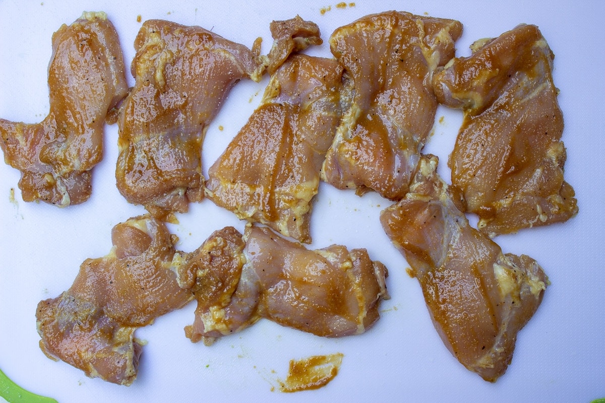 marinated chicken on cutting board