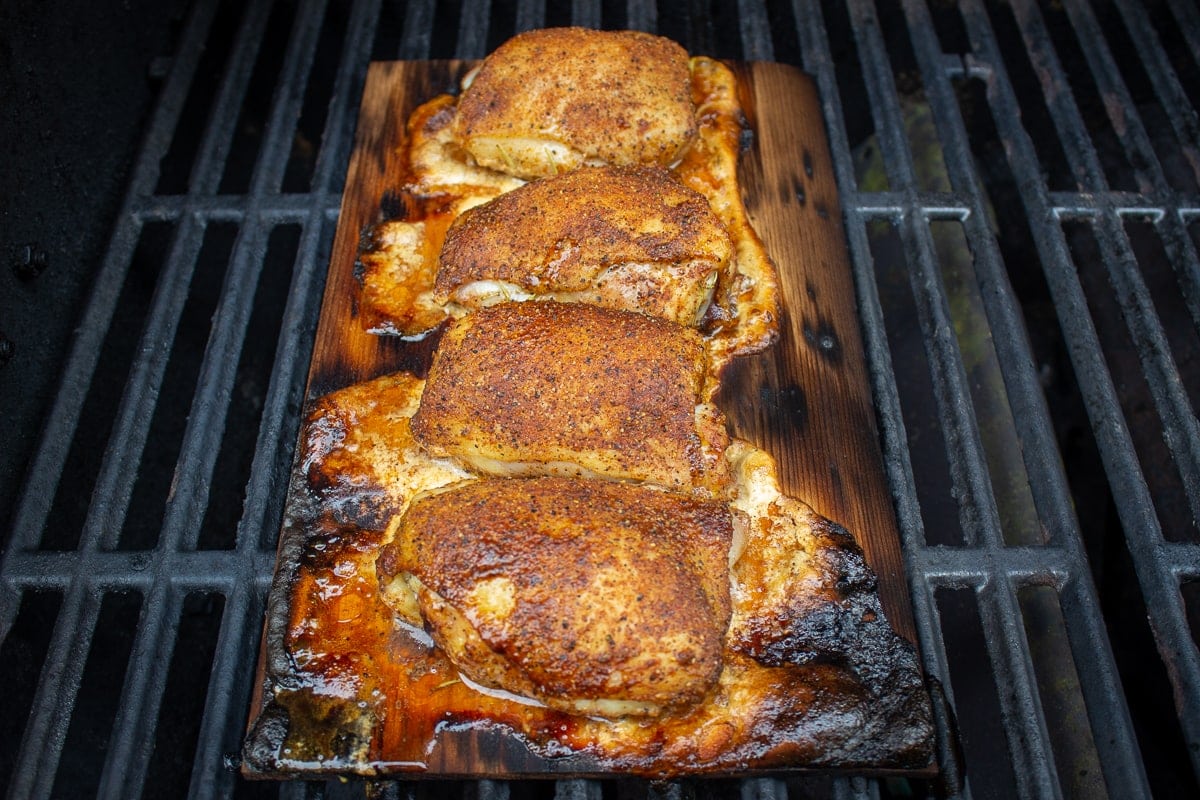 chicken thighs on plank on grill 1