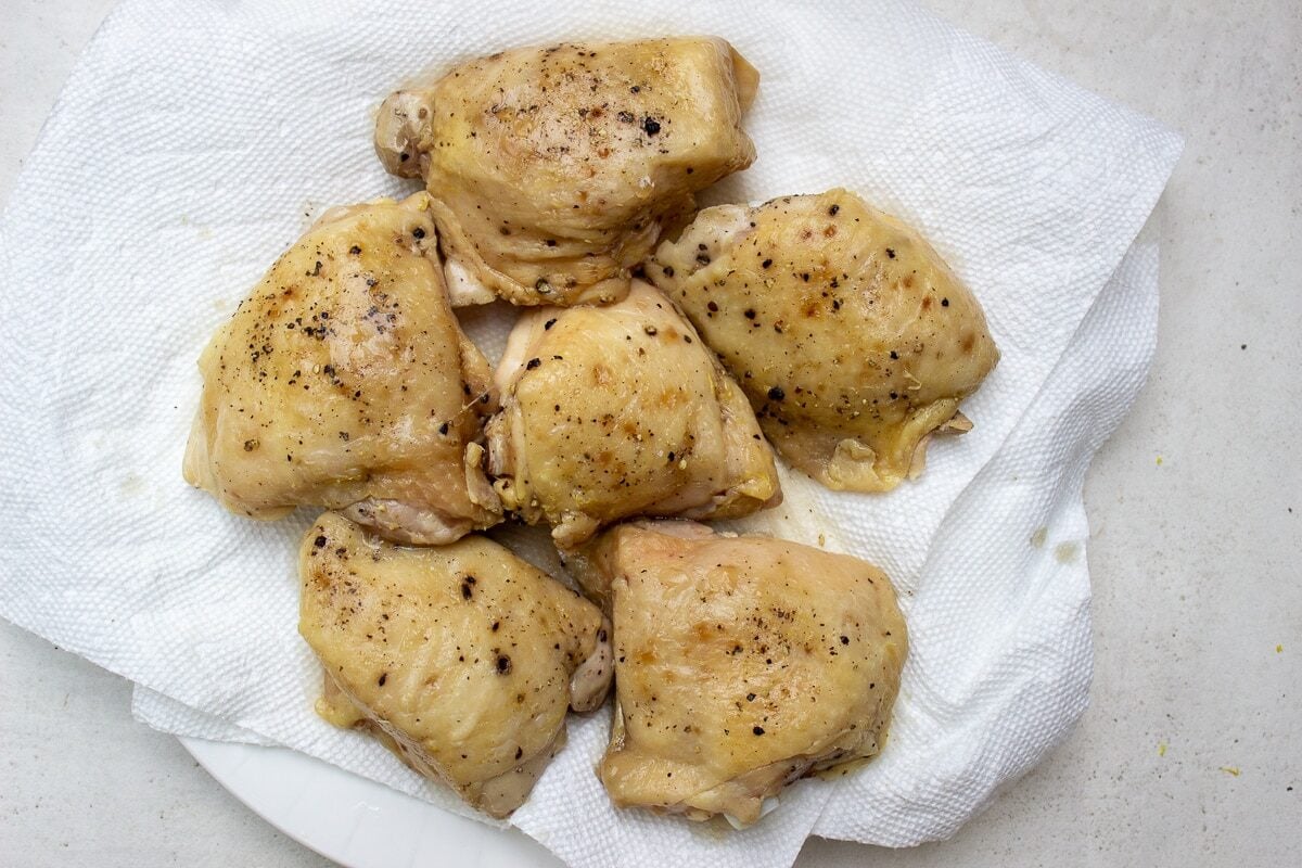 sous vide thighs with sauce on pan