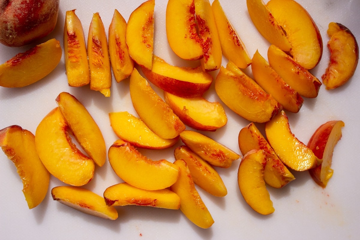 sliced peaches on cutting board