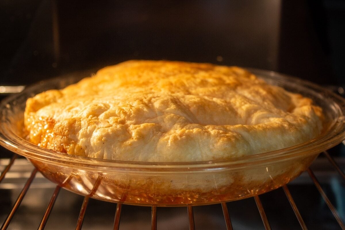peach tarte titin in oven baking