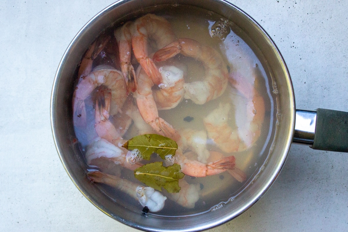 shrimp poaching in a medium pot