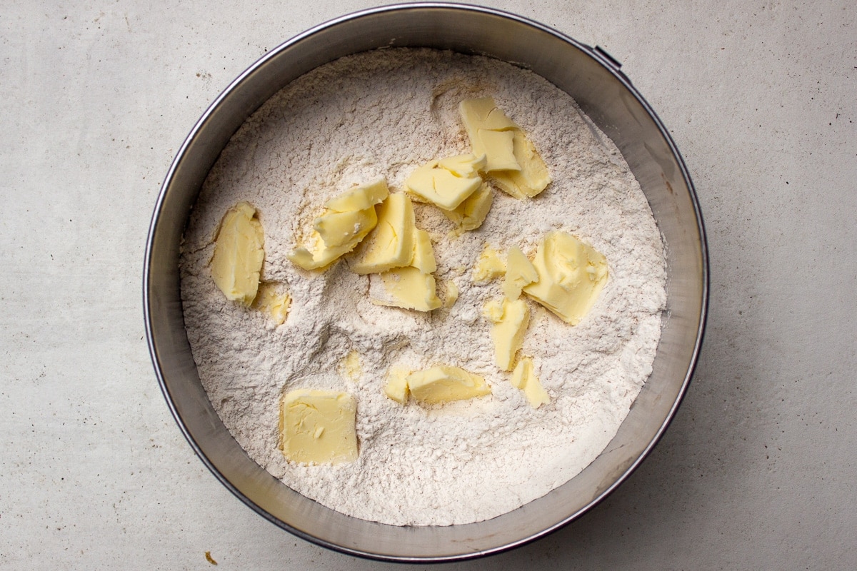 cubed butter with flour in bowl