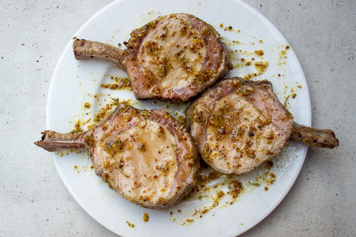 pork chops in marinade on plate