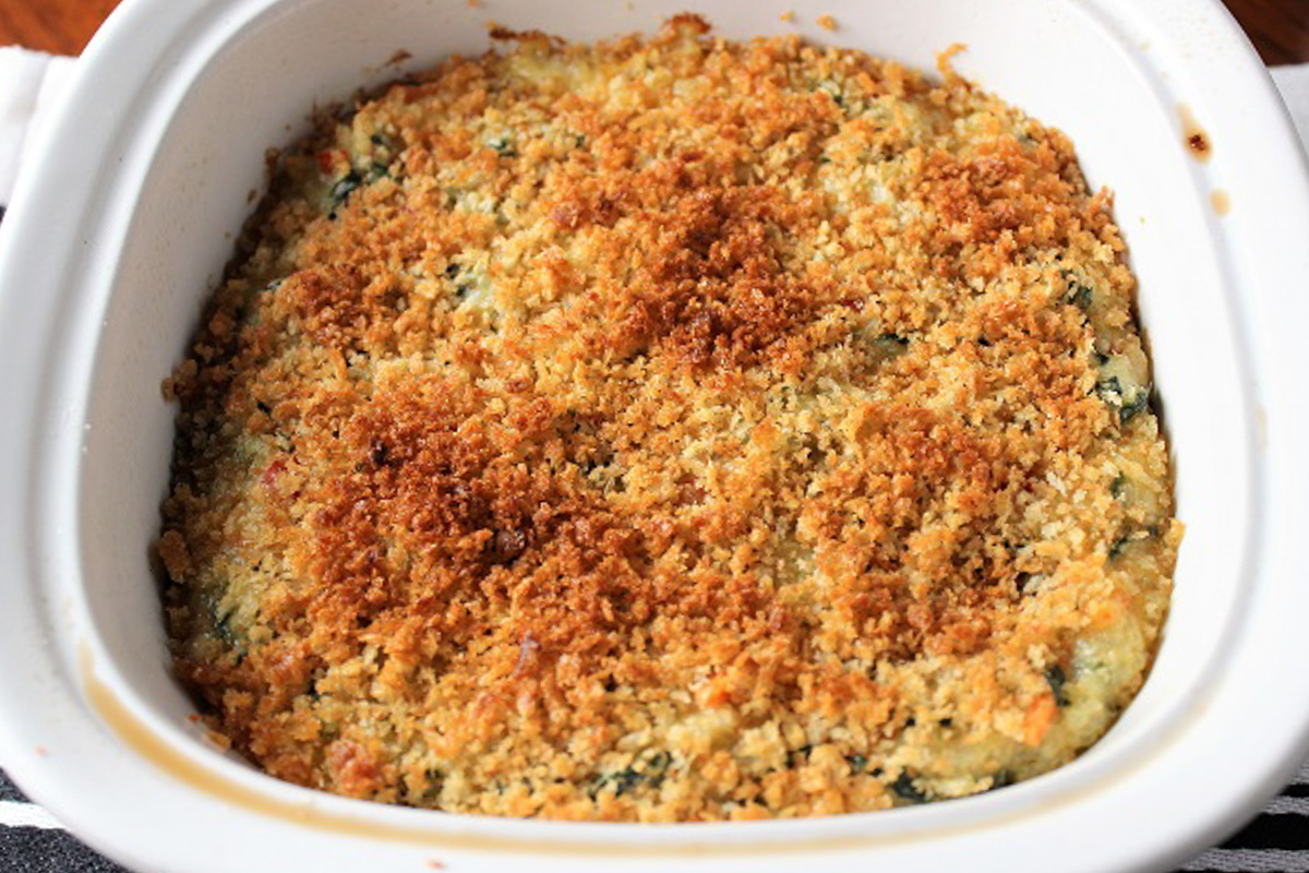 baked quinoa mac and cheese in casserole dish with bread crumb topping