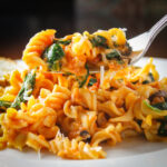 forkful of pasta with spinach tomato and cheese 1
