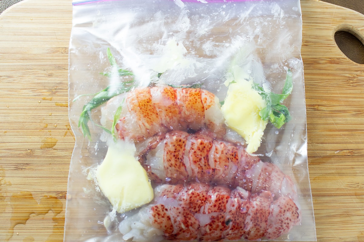 lobster tails in sous vide bag with butter and tarragon