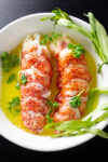 2 lobster tails in butter in dish p1