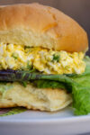 egg salad sandwich on bun with lettuce p