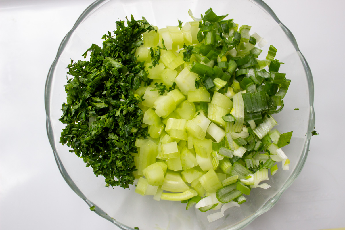 finely chopped celery onion parsley in bowl